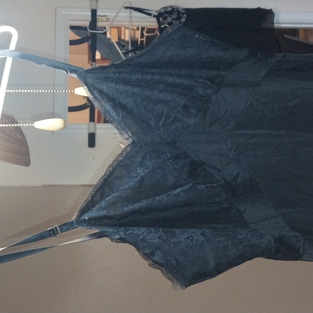 A NIGHT SLIP MADE OF NYLON WITH EMBROIDERED LACE ON THE BREASTS